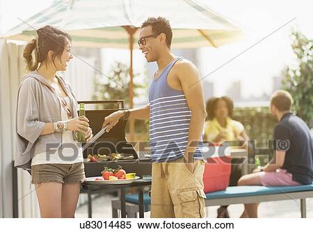 Group of friends enjoying barbeque View Large Photo Image Stock Photography - Group of friends enjoying barbeque. Fotosearch