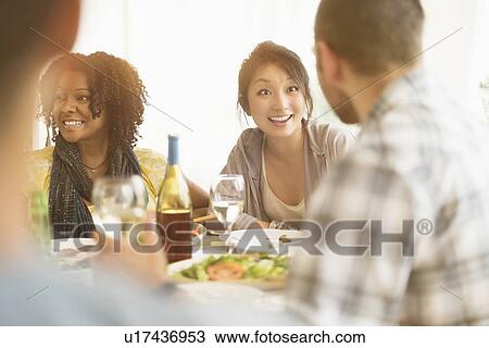 Group of friends enjoying dinner party View Large Photo Image Stock Image - Group of friends enjoying dinner party. Fotosearch