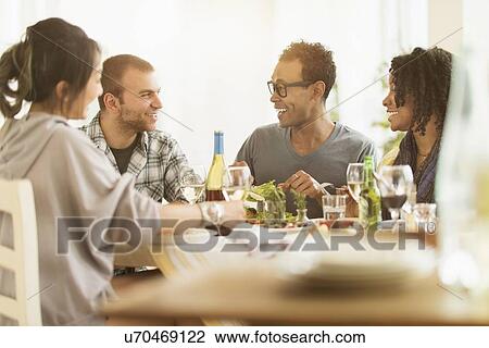 Group of friends enjoying dinner party View Large Photo Image Stock Image - Group of friends enjoying dinner party. Fotosearch