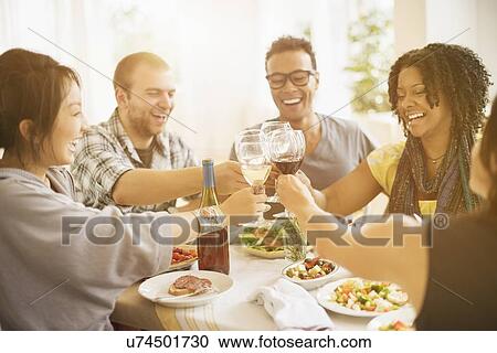 Group of friends enjoying dinner party View Large Photo Image Stock Image - Group of friends enjoying dinner party. Fotosearch