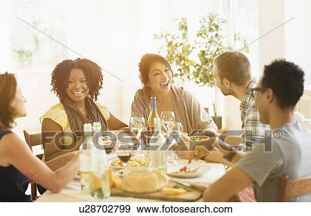 Group of friends enjoying dinner party View Large Photo Image Stock Photo - Group of friends enjoying dinner party. Fotosearch