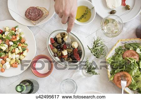 Stock Photo - Hand serving salad. Fotosearch