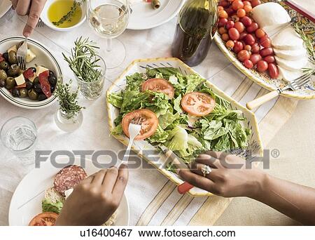 Stock Photo - Hands serving salad. Fotosearch