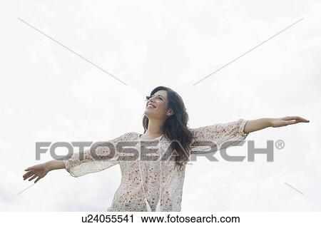 Happy woman against sky View Large Photo Image Stock Image - Happy woman against sky. Fotosearch
