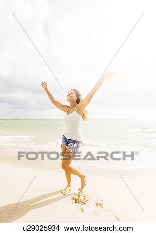 Happy woman on beach View Large Photo Image Picture - Happy woman on beach. Fotosearch