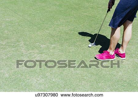 Stock Image - Low section of man playing golf. Fotosearch