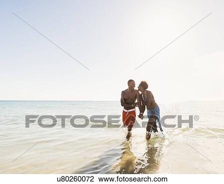 Man and woman holding hands on beach View Large Photo Image Stock Image - Man and woman holding hands on beach. Fotosearch