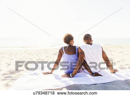 Man and woman sitting on beach View Large Photo Image Stock Photo - Man and woman sitting on beach. Fotosearch