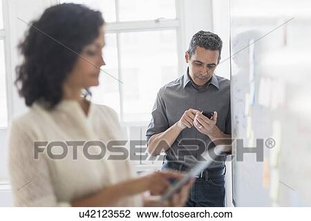 Man and woman working in office View Large Photo Image Stock Image - Man and woman working in office. Fotosearch