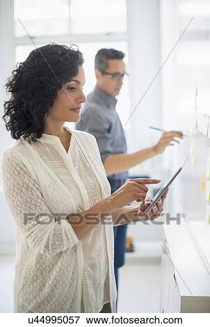 Man and woman working in office View Large Photo Image Stock Photo - Man and woman working in office. Fotosearch