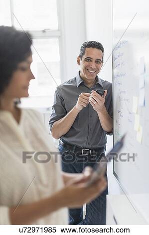 Man and woman working in office View Large Photo Image Stock Photography - Man and woman working in office. Fotosearch