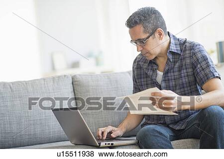 Man doing home finances with laptop View Large Photo Image Stock Photo - Man doing home finances with laptop. Fotosearch