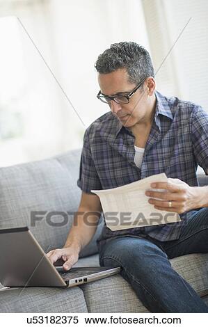 Man doing home finances with laptop View Large Photo Image Stock Photography - Man doing home finances with laptop. Fotosearch