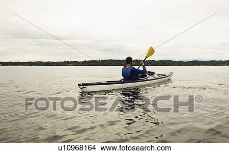Man kayaking on lake View Large Photo Image Picture - Man kayaking on lake. Fotosearch