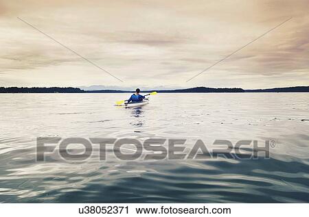 Man kayaking on lake View Large Photo Image Stock Image - Man kayaking on lake. Fotosearch