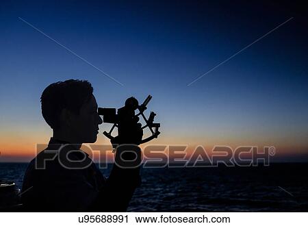 Man looking through sextant View Large Photo Image Stock Image - Man looking through sextant. Fotosearch