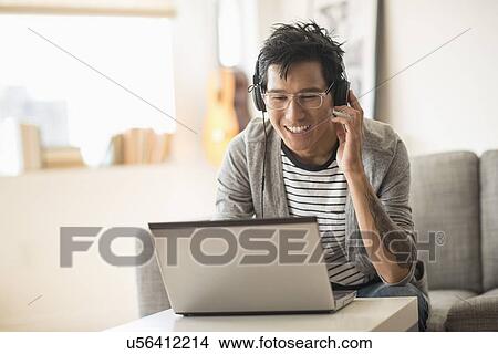 Picture - Man mixing music on laptop. Fotosearch