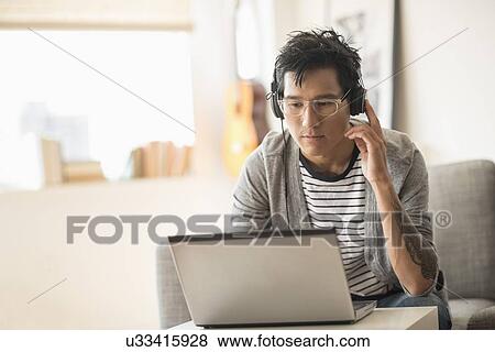 Man mixing music on laptop View Large Photo Image Stock Photo - Man mixing music on laptop. Fotosearch