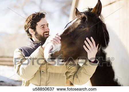 Man stroking horse View Large Photo Image Stock Photo - Man stroking horse. Fotosearch