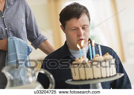 Man with down syndrome celebrating birthday View Large Photo Image Stock Photography - Man with down syndrome celebrating birthday. Fotosearch
