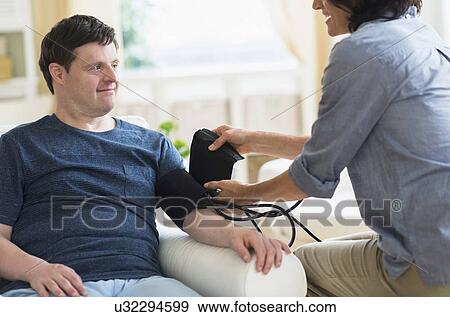 Man with down syndrome having blood pressure measured View Large Photo Image Stock Photo - Man with down syndrome having blood pressure measured. Fotosearch