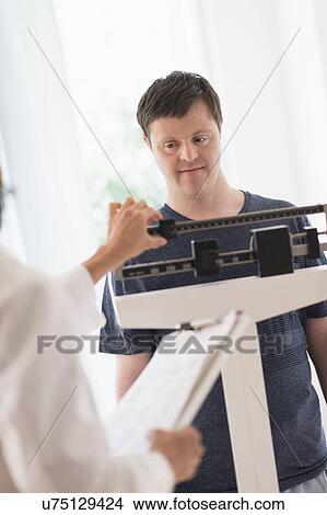 Man with down syndrome in doctors office View Large Photo Image Picture - Man with down syndrome in doctors office. Fotosearch