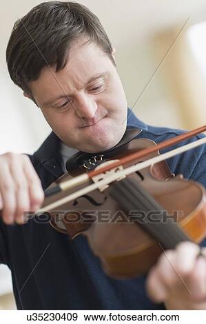 Man with down syndrome playing violin View Large Photo Image Stock Photo - Man with down syndrome playing violin. Fotosearch