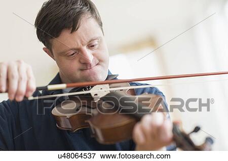 Man with down syndrome playing violin View Large Photo Image Stock Photo - Man with down syndrome playing violin. Fotosearch