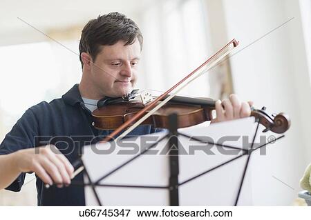 Man with down syndrome playing violin View Large Photo Image Stock Photo - Man with down syndrome playing violin. Fotosearch