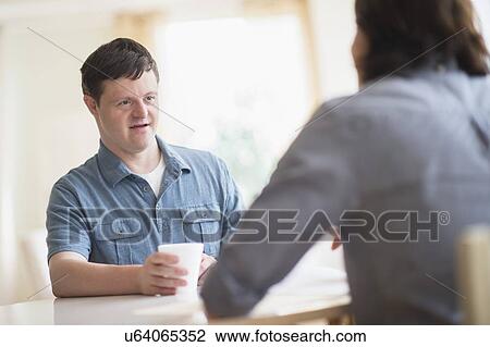 Man with down syndrome talking with care taker View Large Photo Image Stock Image - Man with down syndrome talking with care taker. Fotosearch