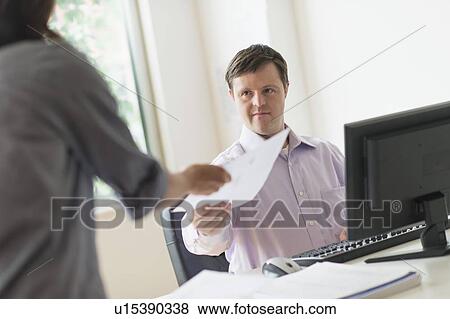 Man with down syndrome working in office View Large Photo Image Stock Photo - Man with down syndrome working in office. Fotosearch