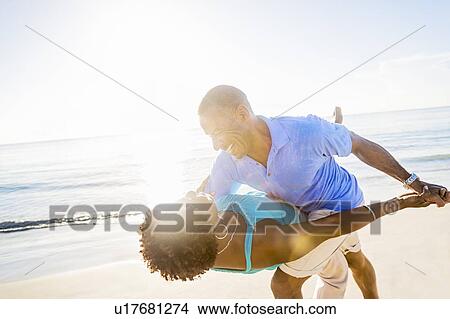 Picture - Mature couple dancing on beach. Fotosearch