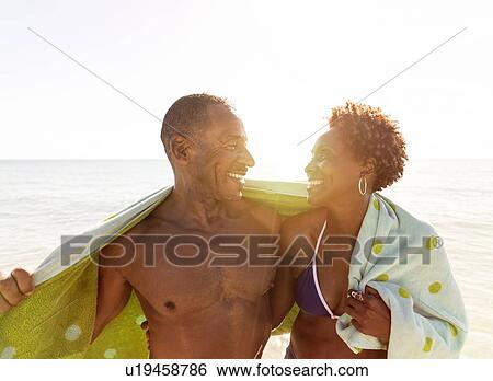 Mature couple embracing on beach View Large Photo Image Stock Photograph - Mature couple embracing on beach. Fotosearch