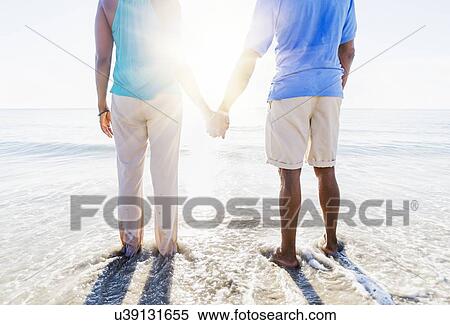 Mature couple standing in sea View Large Photo Image Stock Photography - Mature couple standing in sea. Fotosearch