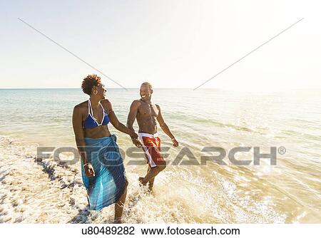 Mature couple walking in sea View Large Photo Image Stock Image - Mature couple walking in sea. Fotosearch