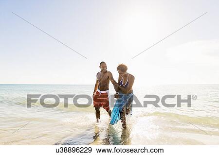Mature couple walking in sea View Large Photo Image Stock Photo - Mature couple walking in sea. Fotosearch