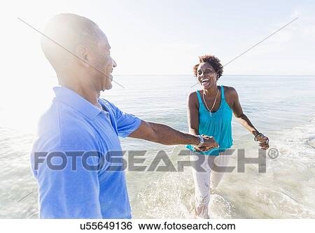 Mature couple walking on beach View Large Photo Image Stock Photograph - Mature couple walking on beach. Fotosearch