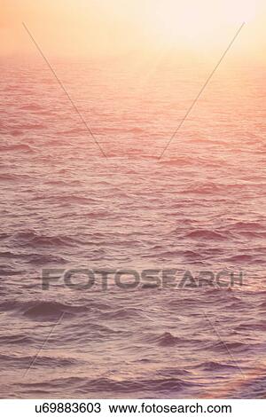 Stock Image - Mediterranean sea at sunrise. Fotosearch