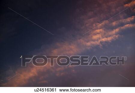 Moon against cloudy sky at sunset View Large Photo Image Stock Image - Moon against cloudy sky at sunset. Fotosearch