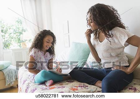 Mother and daughter (8-9) studying together View Large Photo Image Stock Image - Mother and daughter (8-9) studying together. Fotosearch