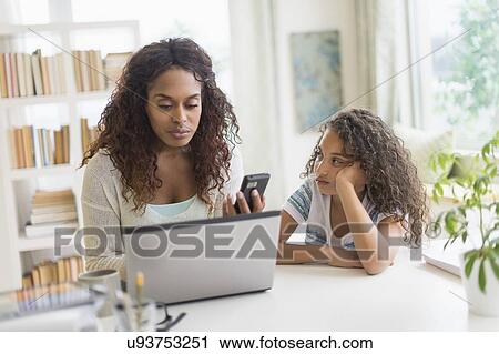 Mother and daughter (8-9) using laptop and smart phone View Large Photo Image Stock Image - Mother and daughter (8-9) using laptop and smart phone. Fotosearch