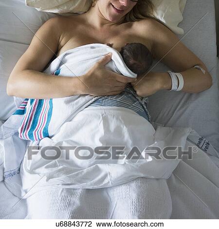 Mother breastfeeding newborn daughter View Large Photo Image Stock Image - Mother breastfeeding newborn daughter. Fotosearch