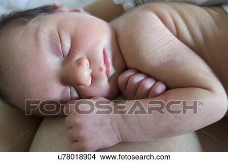 Mother holding newborn daughter View Large Photo Image Picture - Mother holding newborn daughter. Fotosearch