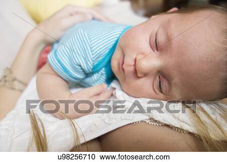 Mother holding newborn daughter View Large Photo Image Stock Image - Mother holding newborn daughter. Fotosearch