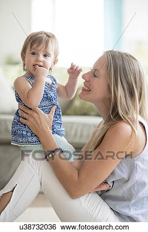 Mother with baby daughter (18-23 months) View Large Photo Image Stock Photograph - Mother with baby daughter (18-23 months). Fotosearch