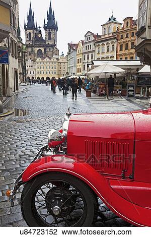 Stock Image - Old town with retro car in foreground. Fotosearch