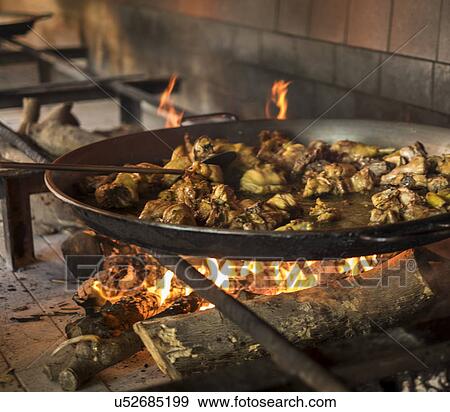 Paella on open fire stove View Large Photo Image Stock Photo - Paella on open fire stove. Fotosearch