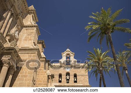 Stock Photo - Palm trees in front of Cathedral of Almeria. Fotosearch