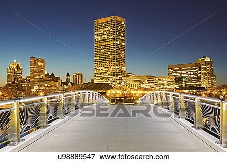 Stock Photo - Pedestrian bridge with skyline in background. Fotosearch