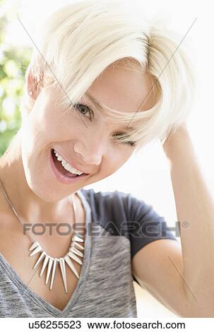 Portrait of blonde woman wearing necklace View Large Photo Image Stock Image - Portrait of blonde woman wearing necklace. Fotosearch